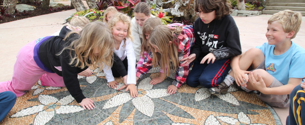 Kids inspecting John Botica's Frangipani artwork